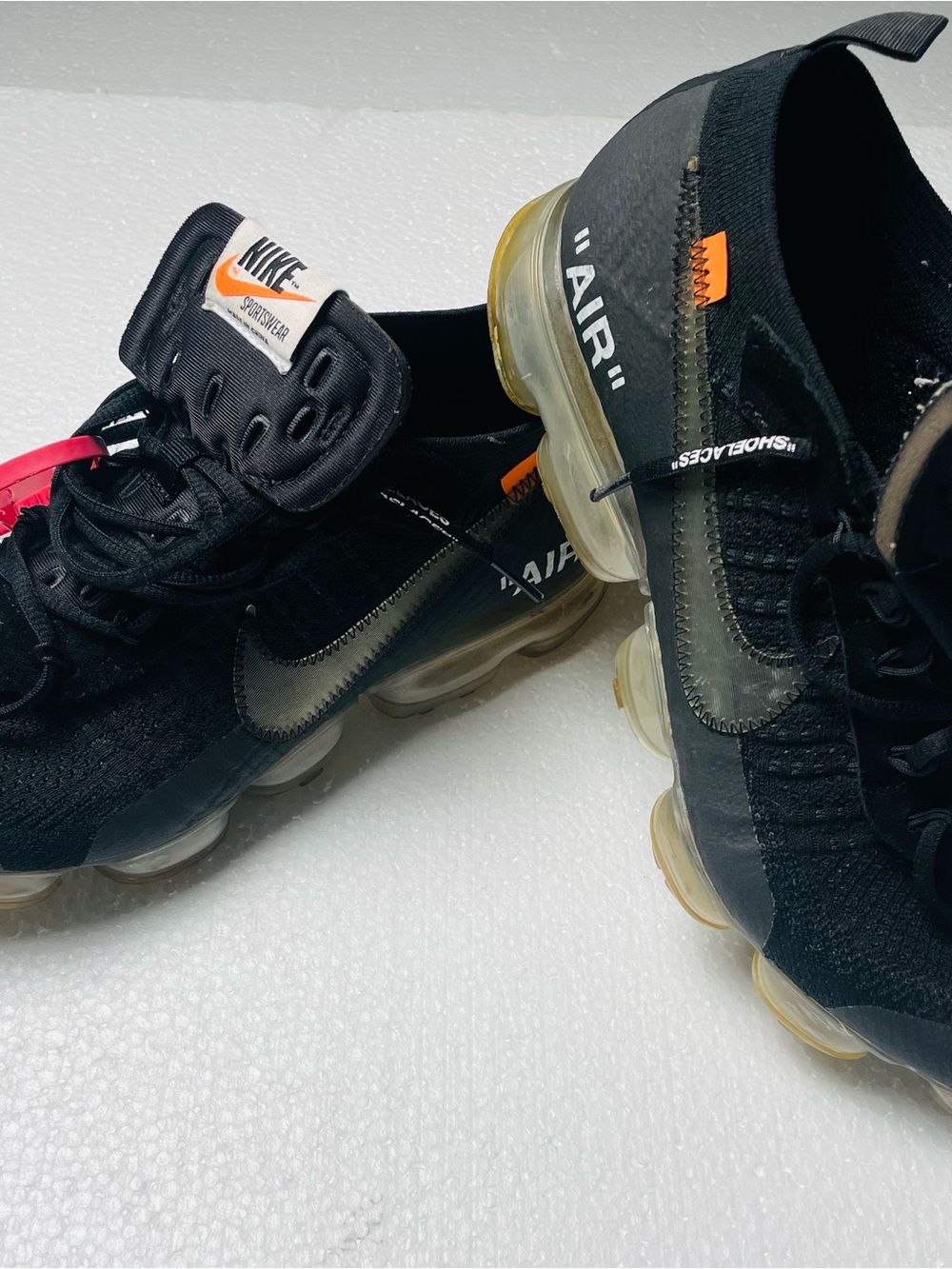 Nike Black High-Top Sneakers with Orange Tongue Logos and Red Zip Tag